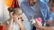 Caring parents making surprise to little birthday girl presenting small bunny