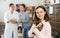 Caring preteen girl standing in animal shelter with kitten in arms