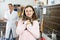 Caring preteen girl standing in animal shelter with kitten in arms