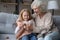 Caring senior grandmother teach knitting little granddaughter