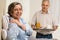 Caring senior man bringing breakfast to wife