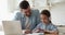 Caring young father helping little primary school daughter doing homework.