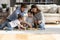 Caring young husband and wife playing toys with preschool children.