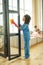 Caring young nurse cleaning the glass door