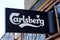 Carlsberg text brand and sign logo of beer front of bar restaurant in french street