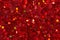 Carmine red figurines on glitter background. Background for creative design or art work.