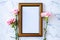 Carnation flower on blank picture frame on marble background, Valentine`s Day, Mother`s Day or Birthday background