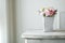 Carnation flower in cement pot on vintage cabinet at the bedroom