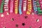 Carnaval festive curling colorful paper streamer decorations on pink background