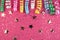 Carnaval festive curling colorful paper streamer decorations on pink background