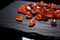 carnelian stones scattered on a black mat