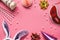 Carnival accessories set on pink background. Birthday or winter party props. Honeycomb balls, hair hoop in shape of rabbit ears,