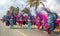 Carnival in Aruba, people in colorful costumes walk in the parade