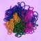 Carnival shiny beads, traditional carnaval accessories. Mardi gras frame or border on purple background, masquerade masks and