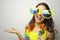 Carnival time. Young woman with big funny sunglasses and carnival garland smile at camera and show your product or text