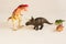 Carnivorous dinosaur tyrannosaurus rex in battle with horned triceratops. plastic dinosaur figures of extinct ancient creatures