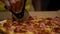 Carnivorous pizza made of bacon, sausage and ham. Fast-food photography detail view of a pizza in a delivery box. Home delivered f