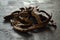 Carob. Healthy organic sweet carob pods on gray wooden background closeup.