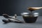 Carob molasses in glass bowl and in wooden spoon and carob pods on rustic background