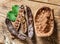 Carob pods and carob beans on the wooden table