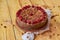 Carob tart with cherries ans raisins on the wooden background. Powdered carob pie with cherries