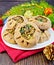 Carols in dish with mushrooms and Christmas decorations on board