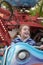 On the carousel of an amusement park, a cheerful teenage girl