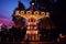 Carousel Merry go round in amusement park at evening city