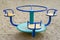 Carousel is on playground. The concept of childhood, parenting, games. Children`s iron carousel
