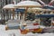 Carousel in the snow, a bright multi-colored fun ride empty littered with snow, winter is not the season