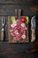Carpaccio beef, with Radish and garnet, on wooden serving board, on old dark  wooden table background, top view flat lay, with