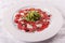 Carpaccio , beef steak salad. Summer launch, healthy eating concept. white plate with sauce. salad served in italian