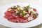 Carpaccio di Manzo. Carpaccio with veal, pesto and Parmesan