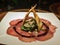 Carpaccio of meat garnished with fine herbs triangular bread and gourmet sauces