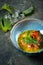 Carpaccio salmon fillet with shiso leaves in a blue bowl