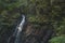 Carpathian mountain Ukraine nature scenic view soft focus forest waterfall water motion from cascade rocks in green spring foliage