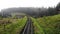 Carpathian mountains misty landscape with railroad.