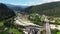 Carpathian Mountains with River and Beautiful Road aerial view.