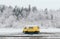 Carpathians, Ukraine - December 2019: yellow camper van with winter forest on background