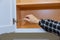 Carpenter adjusting a cabinet metal hinges for doors