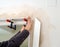 Carpenter adjusting the top frame of a new sliding door with a pressure handle clamp