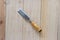 Carpenter chisel on wood background