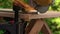 A carpenter cuts a steel rod with an electric hammer on workbench. Macro. A narrow zone of sharpness.