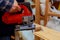 Carpenter cutting electric jigsaw cutting a piece of wood