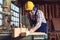 Carpenter cutting a piece of wood in his woodwork workshop