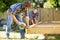 Carpenter Cutting Wood With Handheld Saw While