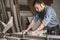 Carpenter cutting wood on workbench