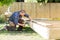 Carpenter Drilling Wood At Construction Site