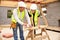 Carpenter With Female Apprentice Working On Building Site