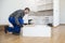 The carpenter finalizing the assembly of the kitchen shelf